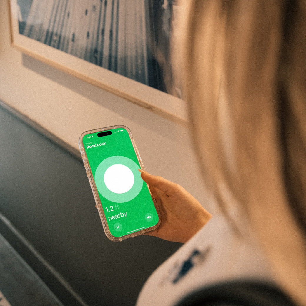 A traveler uses their iPhone to track a RockLock jewelry lockbox with Apple AirTag integration. The precision tracking feature ensures peace of mind, keeping valuable jewelry secure and easily locatable while on the move.